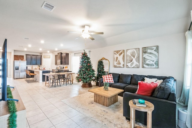 tiled living room with ceiling fan