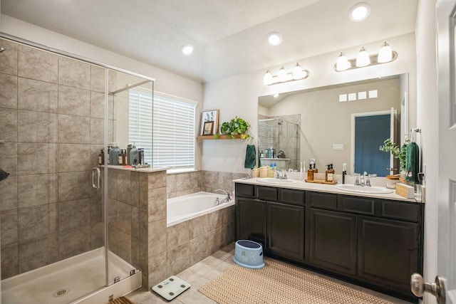 bathroom featuring tile patterned flooring, vanity, and plus walk in shower