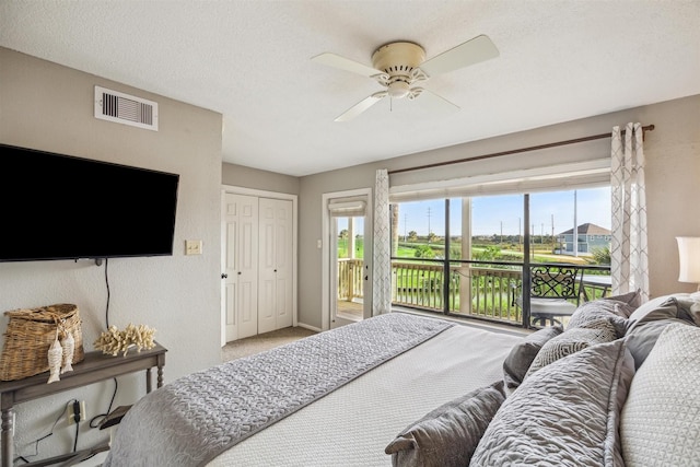 bedroom with multiple windows, a closet, access to outside, and ceiling fan