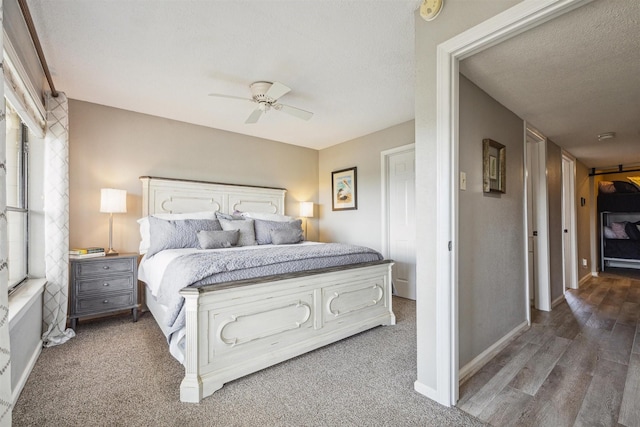 bedroom featuring ceiling fan, a textured ceiling, and hardwood / wood-style flooring