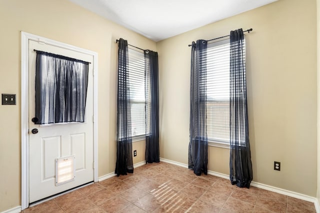 foyer with light tile patterned floors and a wealth of natural light