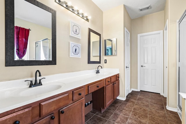 bathroom featuring tile patterned floors, vanity, and walk in shower