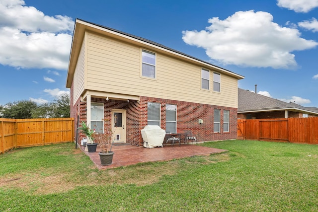 back of property with a lawn and a patio