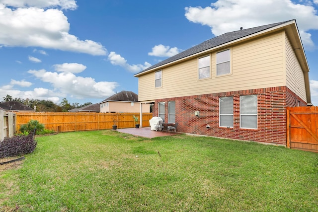 rear view of property with a patio area and a lawn