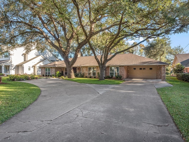 ranch-style home with a front yard and a garage