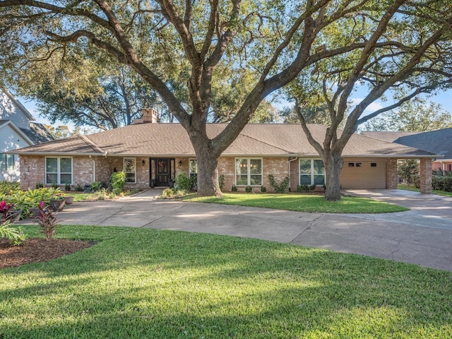 ranch-style home with a garage and a front lawn