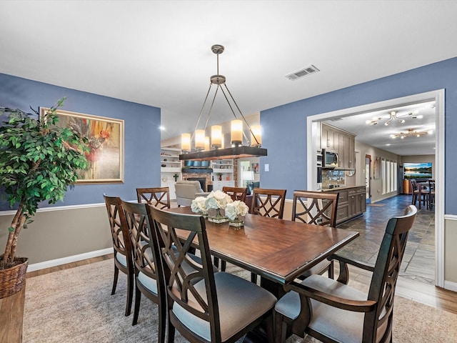 dining space with a fireplace and light hardwood / wood-style floors