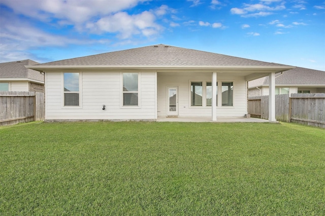 rear view of house featuring a patio and a lawn