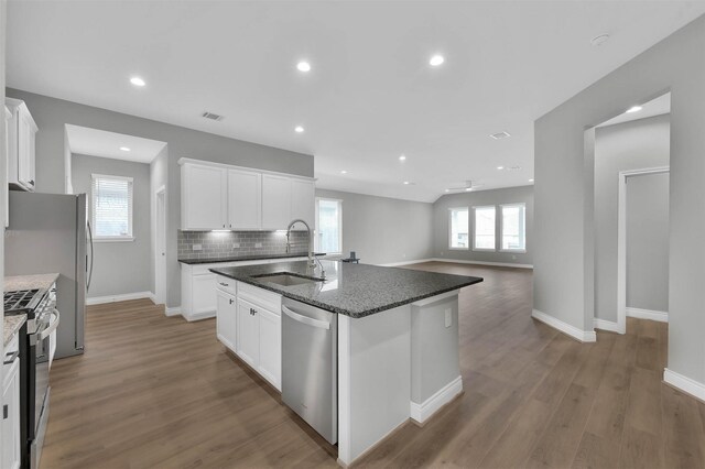 kitchen featuring a center island with sink, plenty of natural light, sink, and appliances with stainless steel finishes