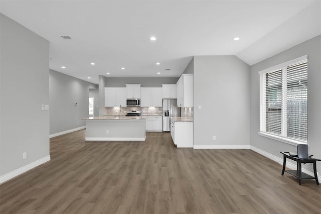 kitchen with white cabinetry, hardwood / wood-style floors, and appliances with stainless steel finishes