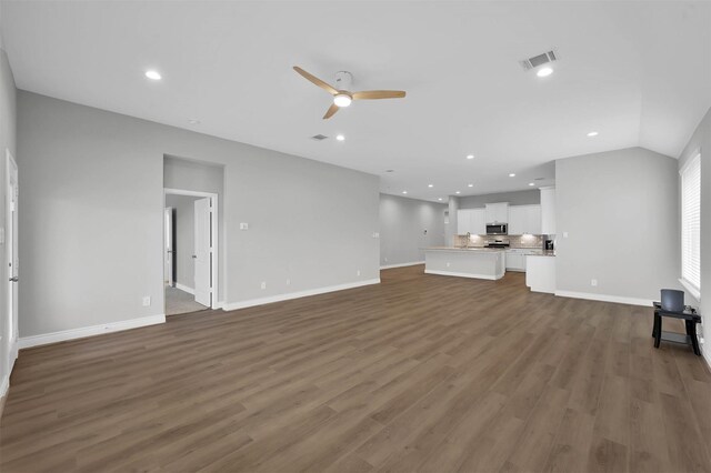 unfurnished living room featuring ceiling fan, dark hardwood / wood-style flooring, and lofted ceiling