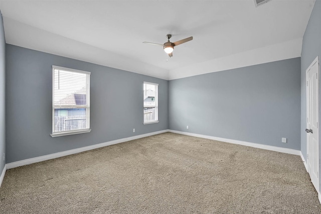 carpeted empty room with plenty of natural light and ceiling fan