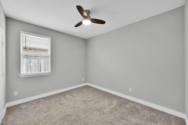 carpeted empty room featuring ceiling fan