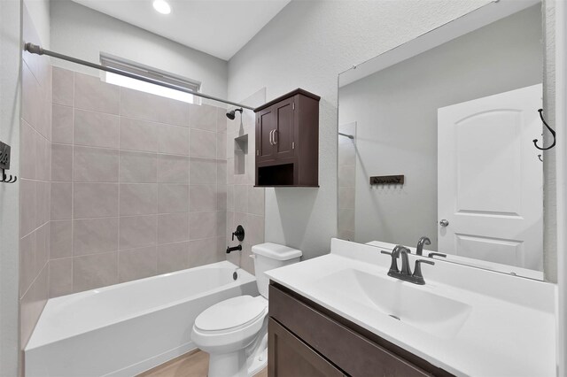 full bathroom featuring vanity, toilet, and tiled shower / bath combo