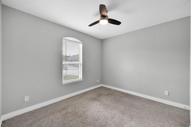 spare room featuring carpet flooring and ceiling fan