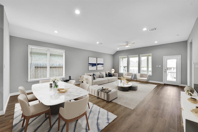 dining space featuring ceiling fan, wood-type flooring, and vaulted ceiling