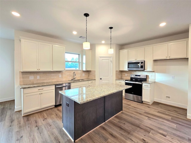 kitchen featuring white cabinetry, a center island, and appliances with stainless steel finishes