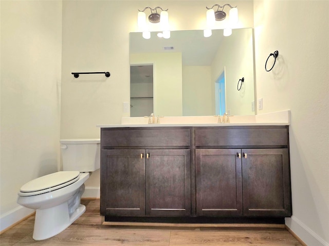 bathroom featuring hardwood / wood-style floors, vanity, and toilet