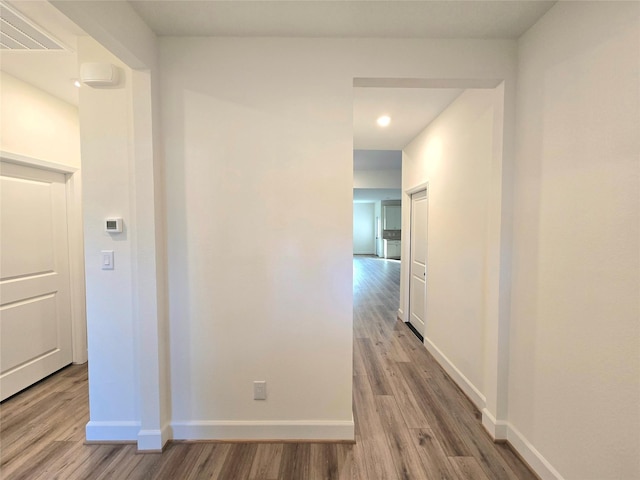 corridor featuring hardwood / wood-style floors