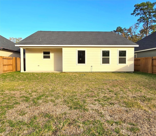 back of property featuring a yard