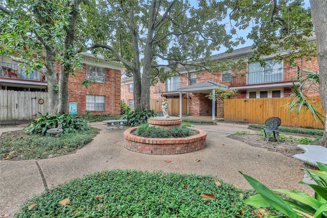 view of home's community featuring fence