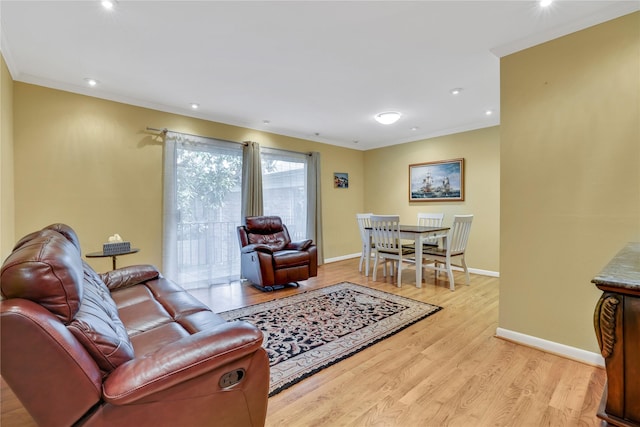 living room with ornamental molding and light wood-type flooring