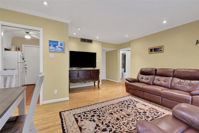 living room with ceiling fan, light hardwood / wood-style floors, and ornamental molding