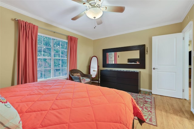 bedroom featuring ceiling fan, crown molding, and light wood-type flooring