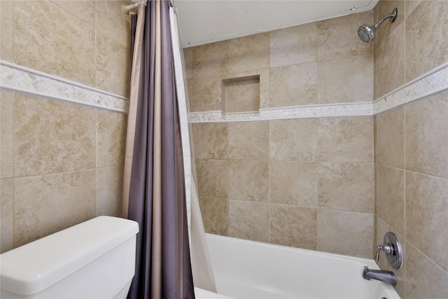 bathroom featuring shower / bathtub combination with curtain and toilet