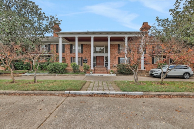 2824 Briarhurst Dr Unit 12, Houston, TX 77057 - neoclassical home with brick siding and a chimney