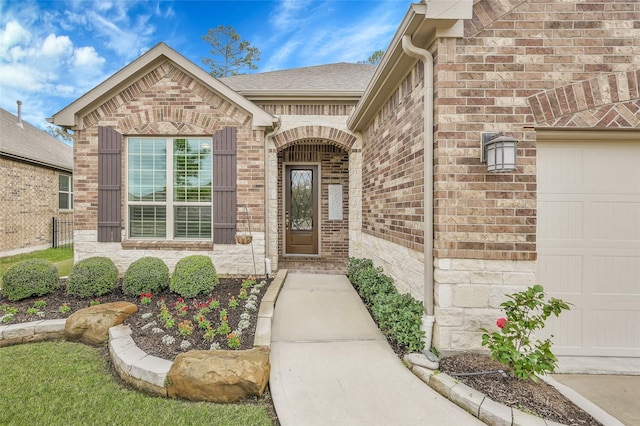 doorway to property with a garage