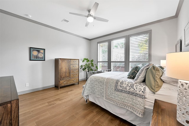 bedroom with ceiling fan, hardwood / wood-style floors, and crown molding