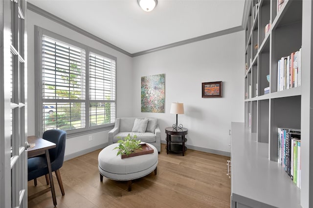 office area with wood-type flooring and ornamental molding