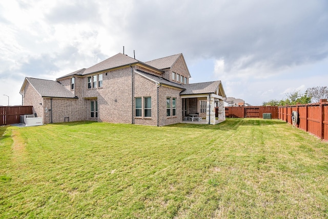 back of house with a lawn, ac unit, and a patio