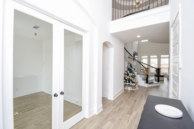 interior space with french doors and a high ceiling