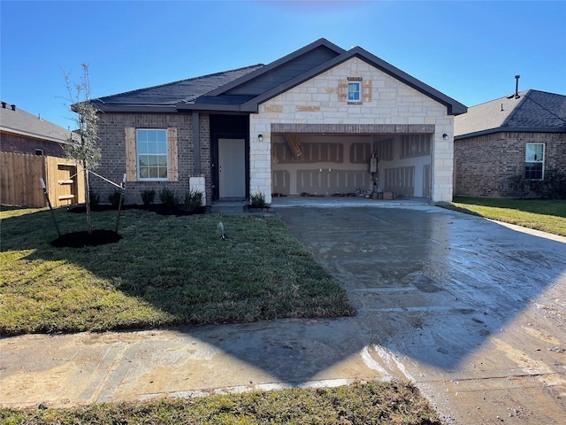 ranch-style home featuring a garage and a front lawn