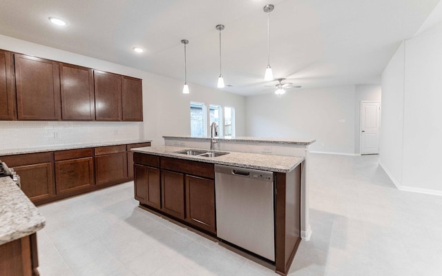 kitchen with dark brown cabinetry, sink, backsplash, stainless steel dishwasher, and pendant lighting