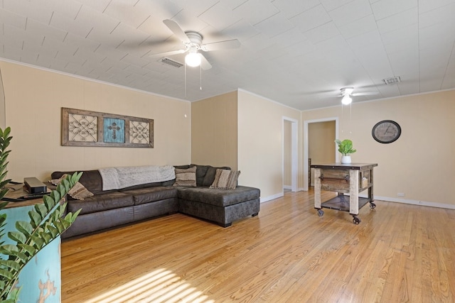 living room with ceiling fan, light hardwood / wood-style floors, and ornamental molding