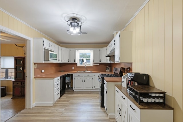 kitchen with white cabinets, crown molding, sink, light hardwood / wood-style flooring, and stainless steel appliances