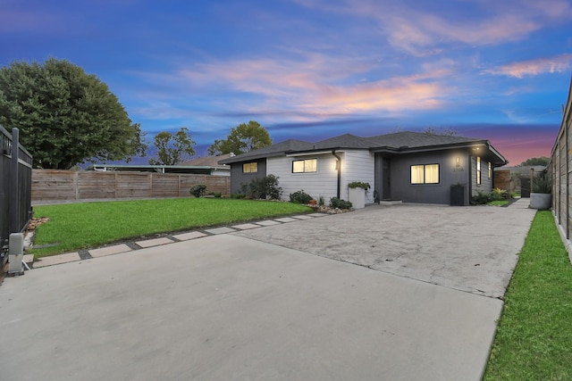 view of front of house with a yard and a patio