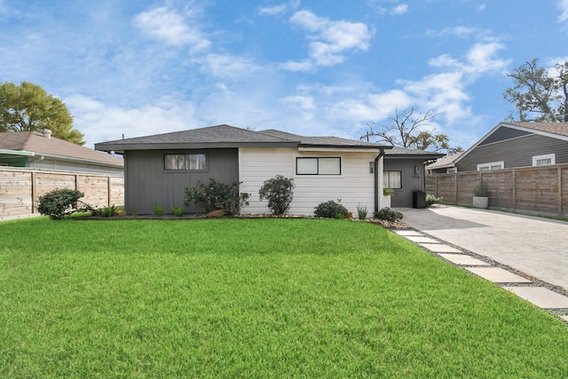 view of front of home with a front yard and a patio