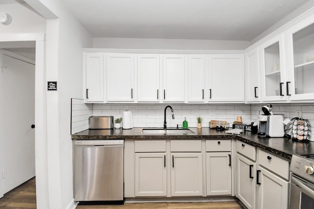 kitchen with sink, white cabinets, stainless steel dishwasher, and stove