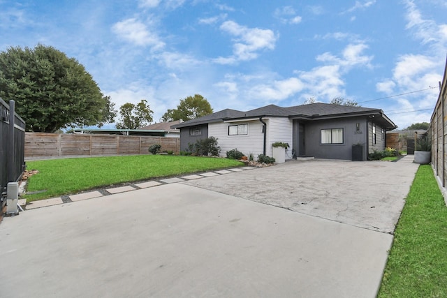 rear view of house with a patio area and a yard