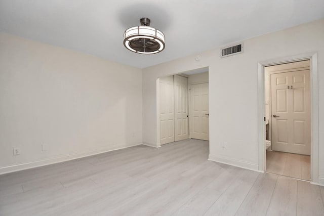 unfurnished bedroom with a closet and light hardwood / wood-style flooring