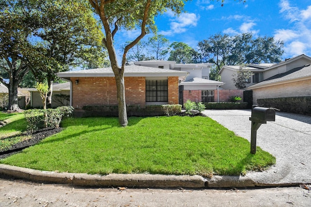 ranch-style home with a front lawn