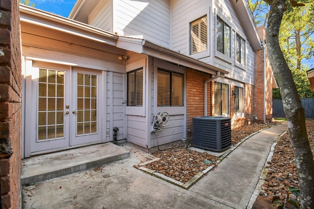 doorway to property featuring french doors and central air condition unit