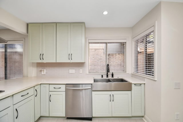 kitchen with backsplash, dishwasher, sink, and a wealth of natural light