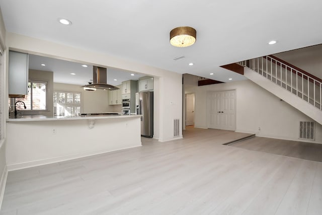 unfurnished living room featuring light hardwood / wood-style floors and sink