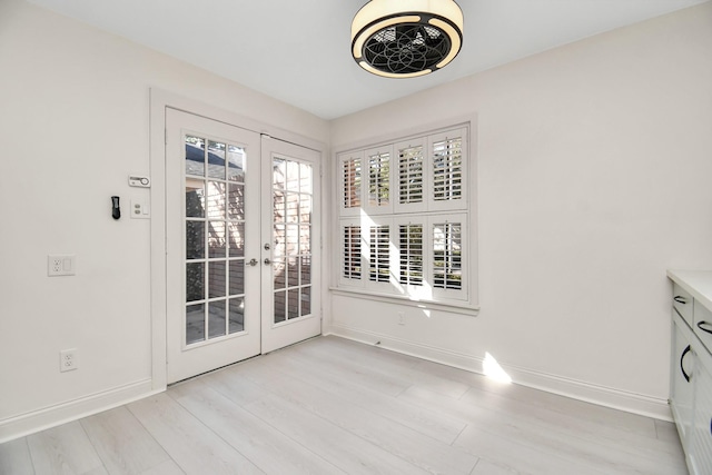 doorway featuring french doors and light hardwood / wood-style floors