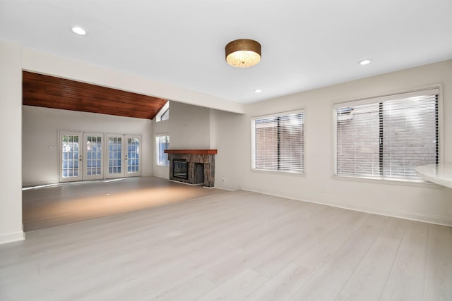 unfurnished living room featuring light hardwood / wood-style floors, lofted ceiling, and wood ceiling